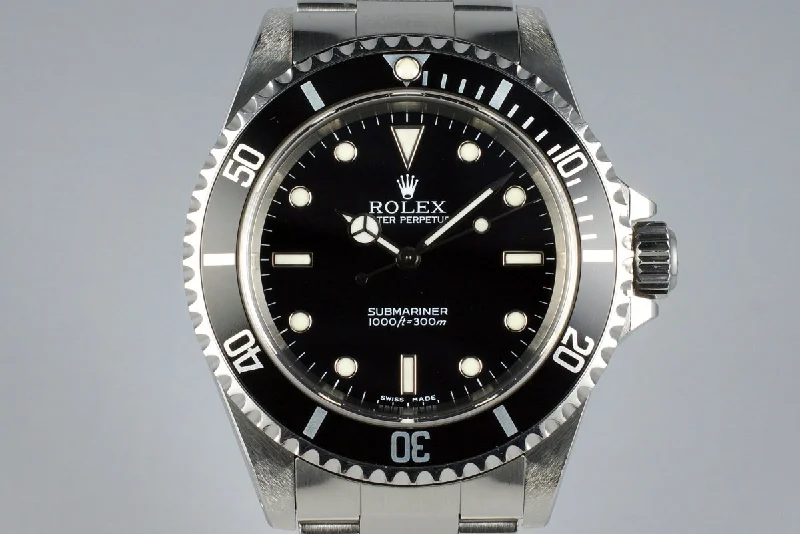 Rolex Day-Date with 18k gold case -2001 Rolex Submariner 14060M